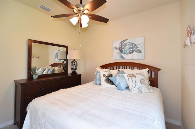 bedroom with baseboards, visible vents, and a ceiling fan