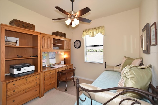 office featuring light carpet, ceiling fan, and baseboards