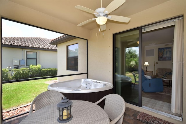 sunroom / solarium featuring a hot tub