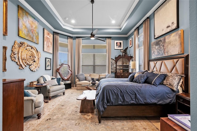 bedroom with ornamental molding, multiple windows, and a raised ceiling