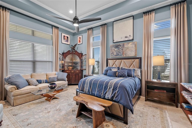 bedroom with tile flooring, ornamental molding, ceiling fan, and a raised ceiling