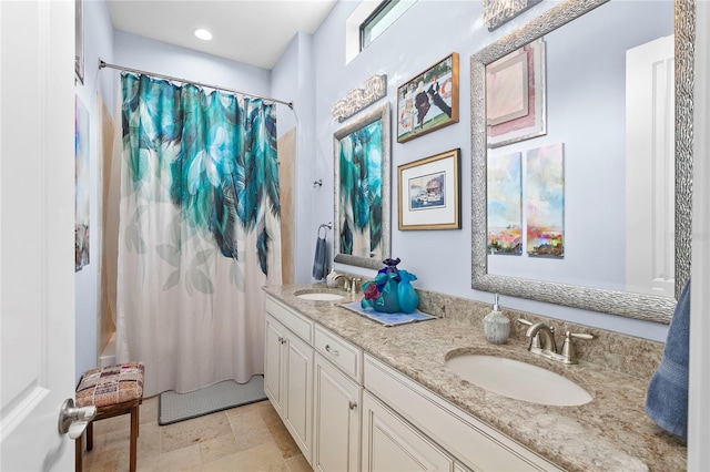 bathroom featuring tile floors and dual vanity