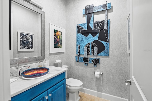 bathroom with tile flooring, toilet, and oversized vanity