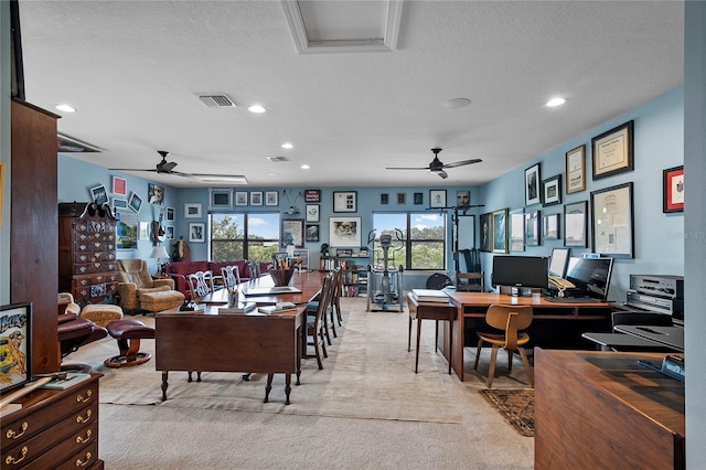 carpeted living room with a healthy amount of sunlight, ceiling fan, and a textured ceiling