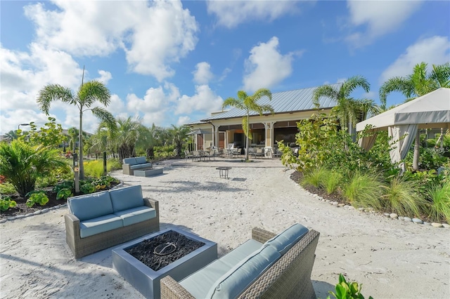 view of patio / terrace featuring an outdoor living space with a fire pit