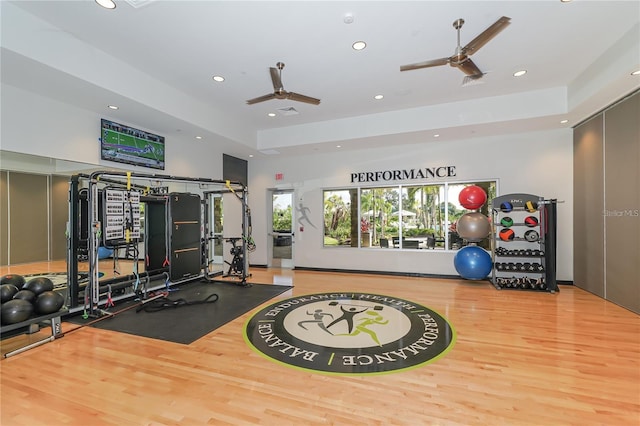 workout area featuring ceiling fan and light wood-type flooring