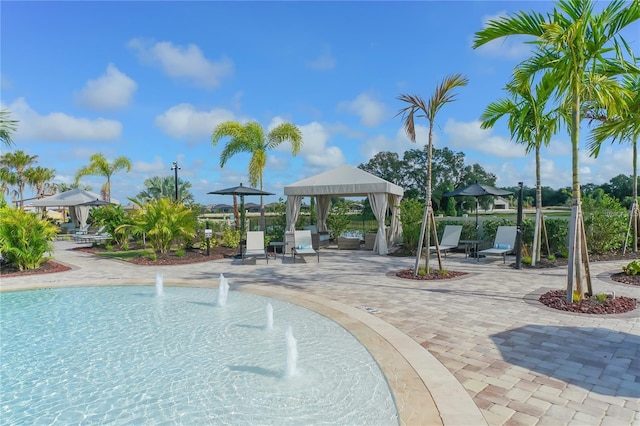 view of swimming pool featuring a patio and a gazebo