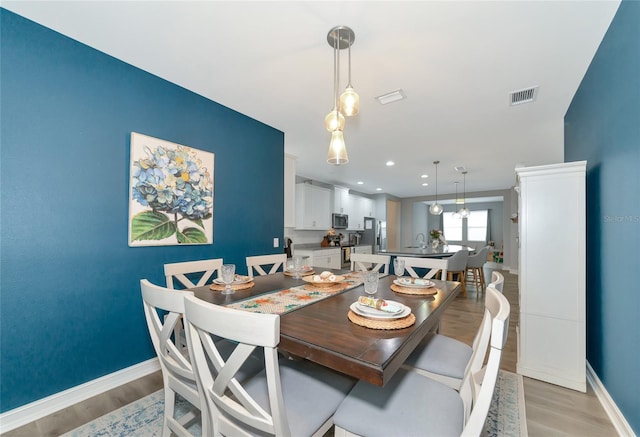 dining area with light wood-type flooring