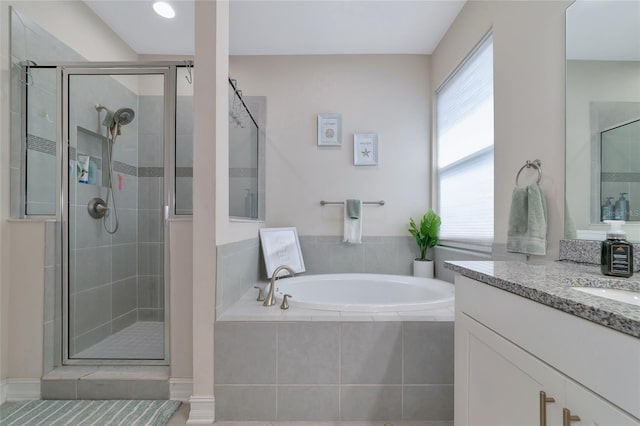 bathroom featuring shower with separate bathtub, vanity, tile patterned floors, and plenty of natural light