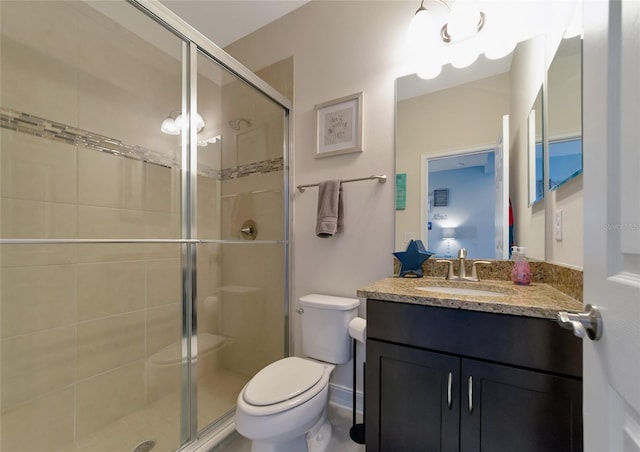 bathroom with vanity, toilet, and walk in shower