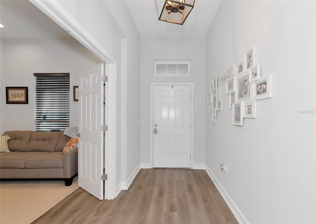 foyer with a notable chandelier and light hardwood / wood-style floors