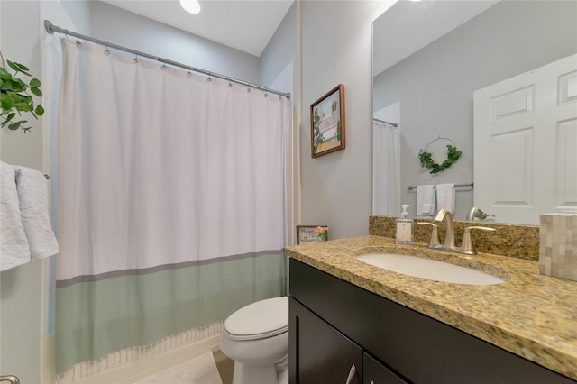 bathroom with vanity, a shower with shower curtain, and toilet