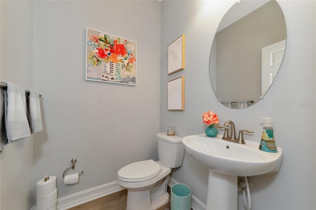 bathroom with hardwood / wood-style floors and toilet