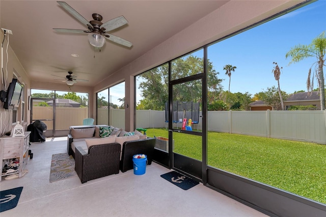 sunroom / solarium featuring ceiling fan