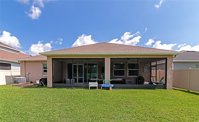 back of property featuring a sunroom, a yard, and cooling unit