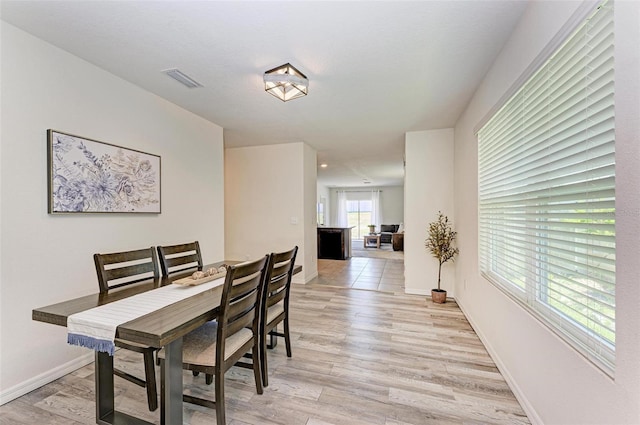 dining space featuring light wood-type flooring