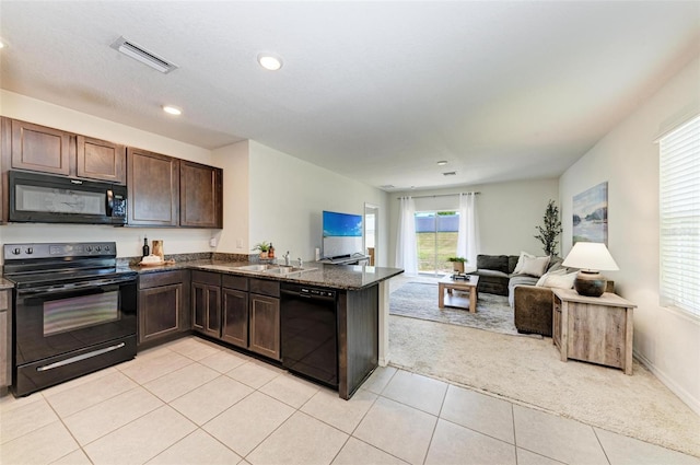 kitchen with kitchen peninsula, dark brown cabinets, light colored carpet, sink, and black appliances