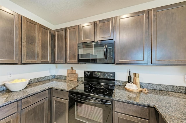 kitchen featuring tile patterned floors, dark stone counters, a textured ceiling, dark brown cabinets, and black appliances