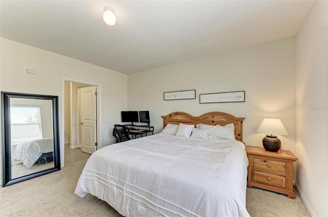 bedroom with light carpet and a textured ceiling