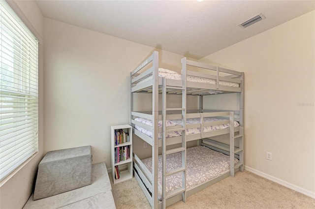 carpeted bedroom with a textured ceiling