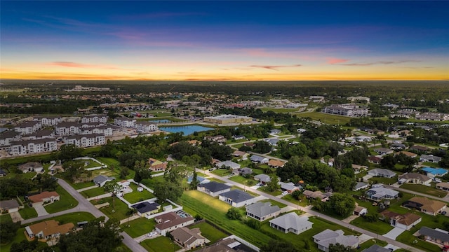 aerial view at dusk featuring a residential view