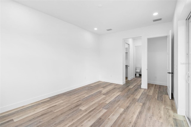 unfurnished bedroom with light wood-style floors, recessed lighting, visible vents, and baseboards