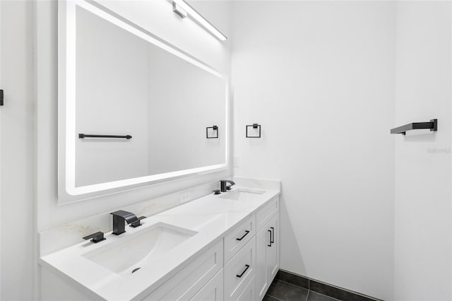 bathroom featuring tile patterned flooring, a sink, and double vanity