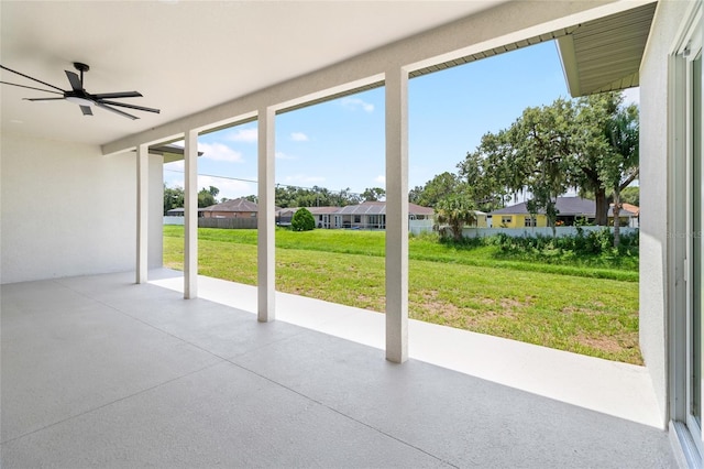 view of patio with a residential view and a ceiling fan