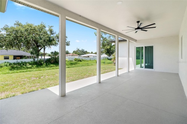 unfurnished sunroom with ceiling fan