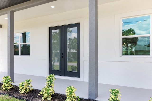 doorway to property featuring stucco siding