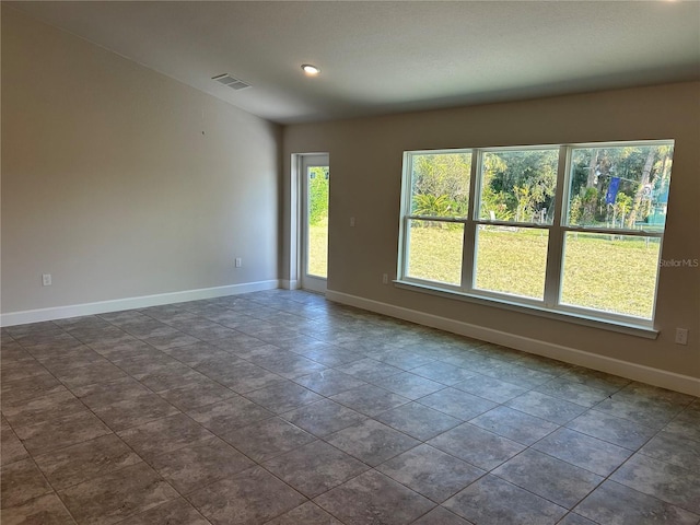 empty room featuring dark tile patterned flooring