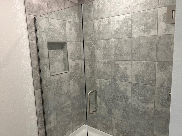 details featuring a shower with shower door