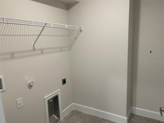 washroom with dark tile patterned flooring and electric dryer hookup