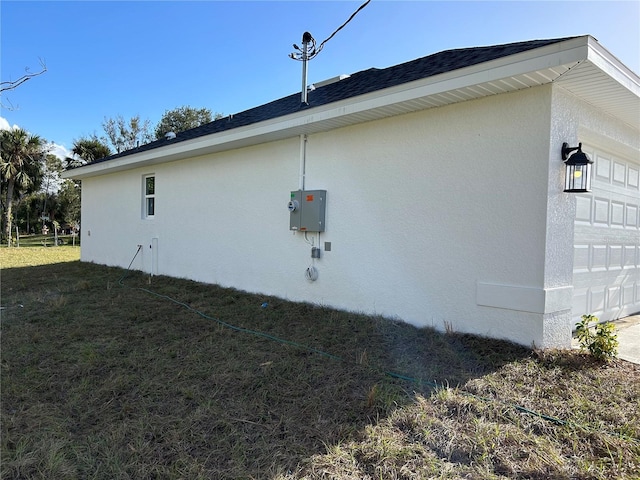 view of home's exterior with a garage and a yard