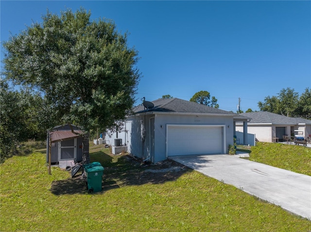 view of front facade featuring a garage, central AC, and a front lawn