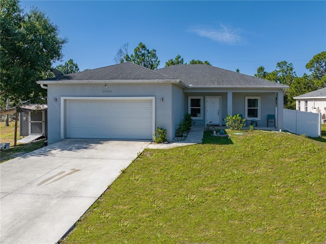 single story home featuring a garage and a front lawn