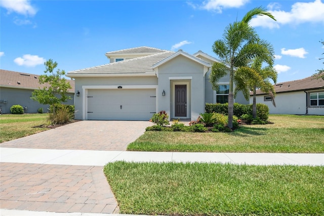 view of front of house featuring a front yard and a garage