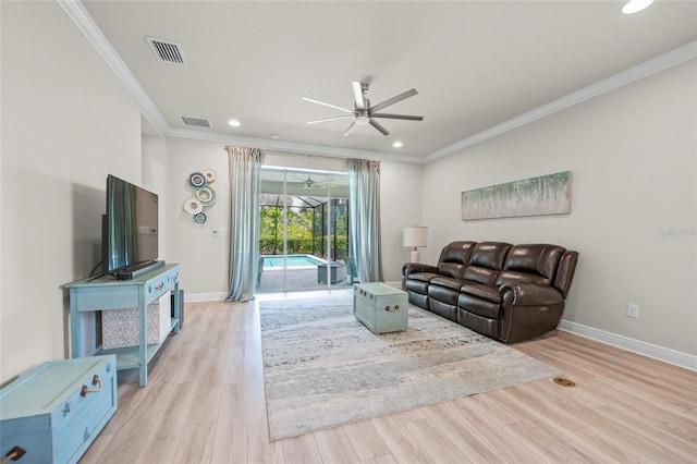 living room with crown molding, light hardwood / wood-style flooring, and ceiling fan