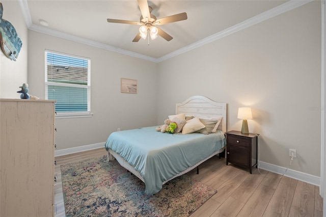 bedroom featuring ceiling fan, light hardwood / wood-style flooring, and crown molding