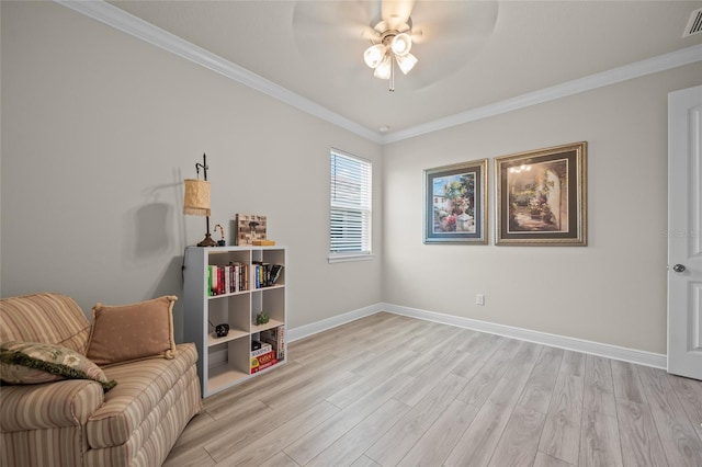 sitting room with light hardwood / wood-style floors, ceiling fan, and crown molding