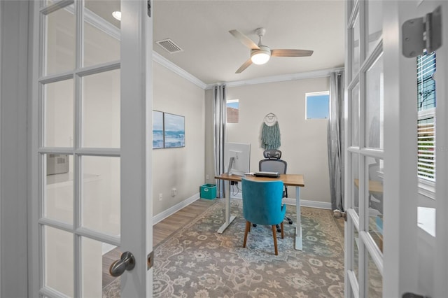 office space featuring hardwood / wood-style floors, ceiling fan, crown molding, and french doors