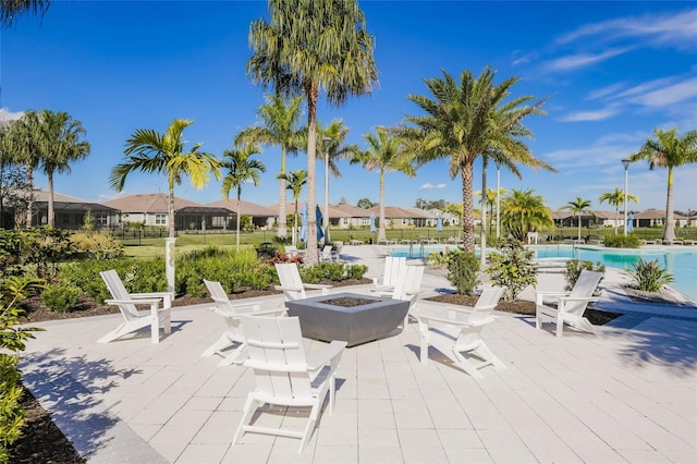 view of patio with an outdoor fire pit and a community pool