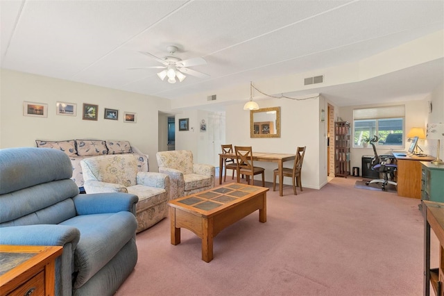 living room with ceiling fan and carpet