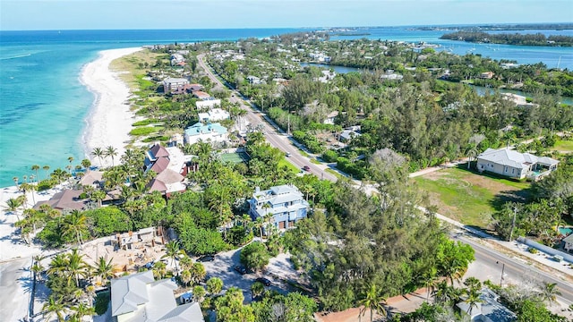 drone / aerial view with a water view and a beach view