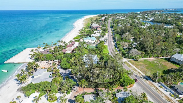 birds eye view of property featuring a water view and a view of the beach