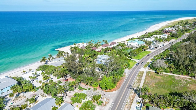 birds eye view of property with a beach view and a water view