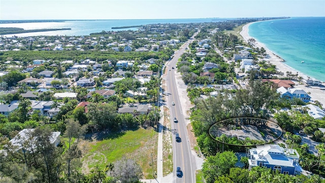 bird's eye view with a water view and a beach view