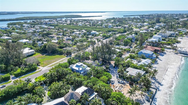 bird's eye view with a water view and a beach view