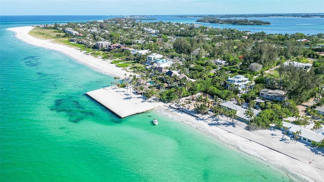 birds eye view of property with a water view and a beach view