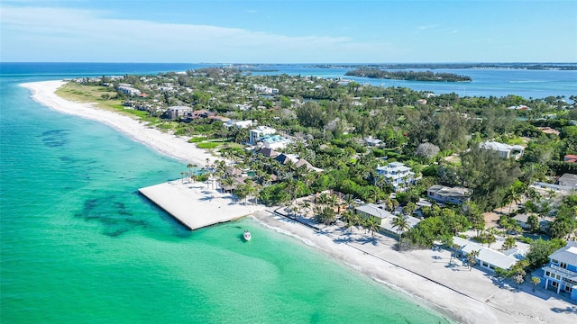 birds eye view of property with a water view and a view of the beach